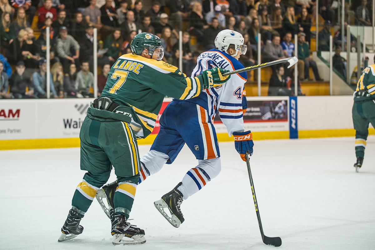 Lange checks Oilers Rookies forward Jaedon Descheneau. 