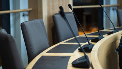 microphones and chairs in a council chamber