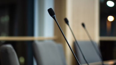 close up of microphones in a council chamber candidates