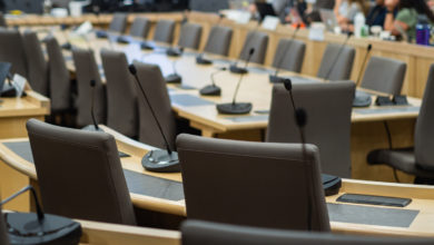 microphones and chairs in a council chamber