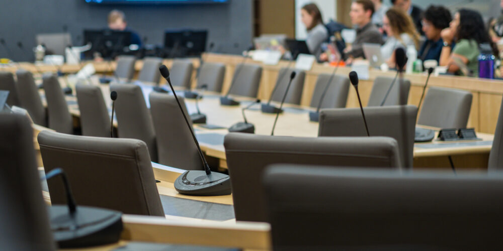 microphones and chairs in a council chamber