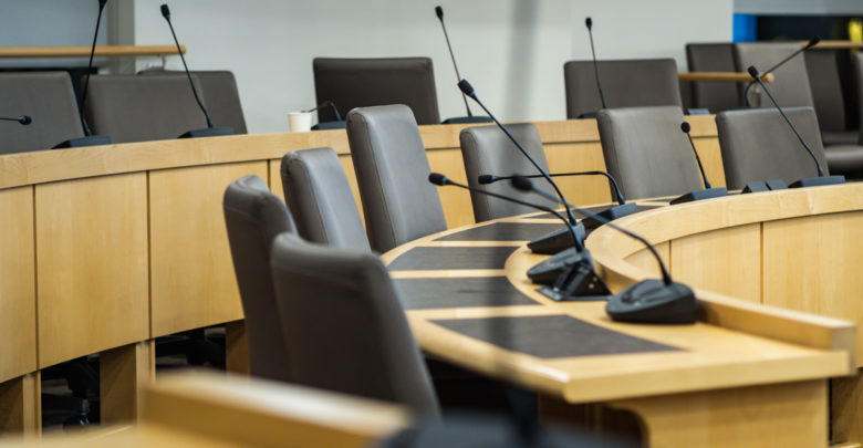 microphones and chairs in a council chamber