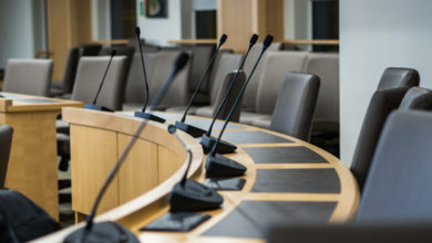 microphones and chairs in a council chamber