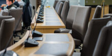 microphones chairs and tables in a council chamber