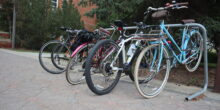 a bike rack full of bikes at the U of A campus
