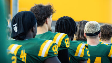 Golden Bears' sideline during the Canadian National Anthem at Foote Field